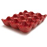 CERAMIC EGG CRATE

Perfect for storing or serving eggs, this ceramic egg-crate holds a dozen eggs at a time. Crafted from ceramic with a brilliant red finish, this egg holder is a stylish way to serve up deviled eggs on any occasion... but we think they taste better after an hour or so spent finding them in the yard.