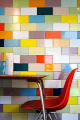 Vintage midcentury fun with a classic Eames chair and a muticolored tile wall. (Pin)