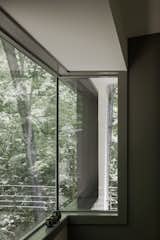 The corner window overlooks the woods. Courtesy of Richard Leo Johnson / Atlantic Archives Inc.  Search “north carolina home renovated swiss aesthetic mind” from Streamlined Modern Living in the North Carolina Forest