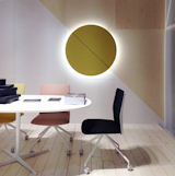Stealth is the name of the game at @ArperSPA where an wall-mounted acoustic panel hides a speaker and lighting and the new task chairs discreetly integrate adjustment handles into the seat's base.