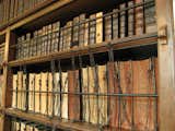 Royal Grammar School Chained Library in Guildford, England-Established in the early 1500s, the Royal Grammar School contains one of few remaining examples of the practice of chaining books to shelves. This allowed important or particularly useful books to be placed in communal areas for public perusal rather than locked away, paving the way for the public library system. Now the Headmaster's Study, the Chained Library holds books that date back to the late 1400s, including two early editions of Sir Isaac Newton's Principia. Photo: traceyp3031