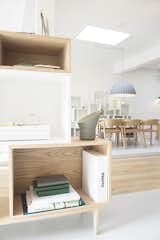Placing the products in an active environment reveals their potential applications. Stacked shelving systems partition workstations as well as contain books and other household items.