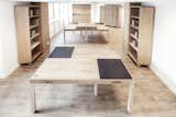 The designers came up with the solution "1 Table – 6 Layouts," a modular collection of six L-shaped tables that fit together in six different configurations.  Photo 2 of 6 in A Modular Meeting Room Features a Table with 6 Possible Layouts