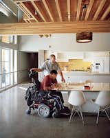 Dining Room, Table, and Chair Ed Slattery, seen here with his son Matthew, wanted to create a sustainable home that is accessible without feeling like a hospital.  Search “Counter-Arguments.html” from This Impressively Accessible Home Has a Tower That Can Be Reached by Wheelchair