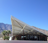 Visitors entering Palm Springs from other desert cities will first come upon the Palm Springs Tramway gas station, designed in 1965 by Albert Frey and Robson Chambers, topped by a hyperbolic paraboloid roof.