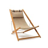 The H55 Easy Chair is crafted in teak, fabric, and stainless steel. The chair features an adjustable frame that can be raised or lowered to create your desired level of lounging. The drape of the fabric creates a hammock-style seat, and the sturdy frame adds stability.