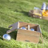 A beautifully designed version of the classic lawn game, Pétanque—a French version of Italy's bocce—the Akiko Petanque set includes a set of six chrome boule balls and a target ball, packaged in a teak box for storing and carrying the game. The box has a hinged cover with a rectangular cut-out, so the teak handle can be used when the box is closed.