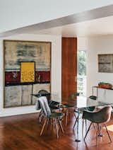 Dining Room, Table, Recessed Lighting, Ceiling Lighting, Chair, and Medium Hardwood Floor In the dining room, artworks by Alan Davie (at left) and Martin Bradley join a Norman Foster dining table.  Photo 14 of 15 in A Midcentury Home Enjoys Views from Every Angle
