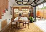 In the dining area, a garage door opens up to the adjacent courtyard, thereby doubling the size of the space. "The garage door simply lifts out of the way and does not need the same amount of space as french doors or even accordion walls," Baird says of the choice.