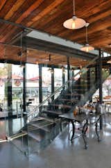 The interior also features simple steel detailing, including this staircase.  Photo 5 of 7 in A Coffee Shop Made With Shipping Containers in South Africa by William Lamb
