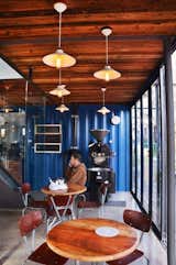 The architects retained the original blue shade of the shipping containers.  Search “impressions from south africa” from A Coffee Shop Made With Shipping Containers in South Africa