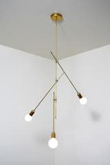 Long and lean, the 'Peak' is all hand polished unfinished brass and three exposed bulbs.