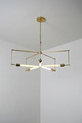 Lines of unfinished hand polished brass and exposed bulbs make up the 'Asterix'.