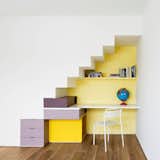This home by O’Neill Rose Architects in Queens, New York, hosts three generations from one family under the same roof. The architects designed this bright desk area under a staircase to provide a distinct space for the youngest family member to complete her schoolwork.