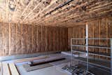 The garage with insulation installed, ready for the application of drywall.  Photo 9 of 9 in Dwell Home Venice: Part 16