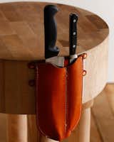 This dorcas knife holder from Lostine is double sheath for kitchen knives—stitched leather attaches nicely with with copper nails for use with butcher block tables