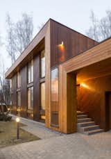 Larch timber planks make up the reddish-gray facade and also adorn the interior walls and floor. Zhidkov says the wood "allowed the house to be an organic insertion into the landscape."