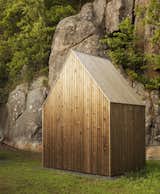 A shed provides storage for the owners’ tools as well as wood for the fireplace. It features the same aged pine finish as the main home.