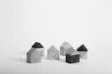 A cluster of black and white houses gives a view of the possible origami creations from the Archifold Architectural Origami Set.