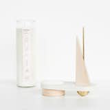 Originally inspired by components of Bower NYC’s furniture line, the Forma Sculptural Candle Set began as a small sculpture. After deciding that the piece needed another element to bring it to life, the designers added a candle—fire—to create a more complete accent. The set is comprised of a soy wax candle with a cedar scent that is housed in a simple glass vessel, a brass tube that can be used as a match extender, a corian surface, glass mirror, maple wood, and brass shapes. All of the elements combine to create a candle holder that is a truly functional work of art.