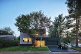 Exterior, House Building Type, Wood Siding Material, and Flat RoofLine An entire floor was added to the house, and the garage was updated.  Search “bungalow” from Sleek Renovation on a Tree-Lined Street in Quebec City