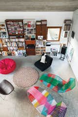The living room includes a “plain old” beanbag, an Other One armchair by Leif Jørgensen for Hay, with a pillow by Candice Enderlé for Cojinudo, and two Tropicalia lounges by Patricia Urquiola for Moroso.

Me, My Shelves, and IThe living room is characterized by a span of shelving on the main wall—a mix of “old shelves collected from my family after my mom and grandfather passed away,” he says. “They inspired my modular shelving system for 

Muuto, which is mixed in.” A dotted Pinocchio rug by the Danish company Hay really ties the room together.

That’s EntertainmentDe Smedt often hosts smaller parties in the living room but plans at least one epic gathering per year: “Early in the summer, the apartment complex has a massive party, where everyone opens their lofts and invites friends; about 1,000 people come. I’ve even had a party with a huge pool—13 feet in diameter—on my terrace.”