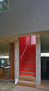 Staircase, Wood Tread, and Metal Railing Given Lima’s dry climate, the architects were able to introduce clever indoor-outdoor gestures such as an open stairwell, and semicovered walkways that allow the trees to provide cover.  Photo 2 of 6 in Concrete Homes We Love by Ivane Soyombo from A Modern Concrete Home in Peru