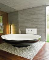 A UFO bathtub by Benedini Associati for Agape lends an alien touch to one of the master bathrooms.
