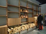 Cassina, part of the Poltrona Frau Group, had one of the moodiest, gorgeous, evocative booths around. This series of wall shelving (accented by raw cut wood) adds to the feeling.  Photo 2 of 13 in Scouting Salone: Shelving and Storage by Kelsey Keith