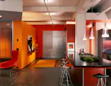Stamberg Aferiat preserved the raw texture of this former printing plant for sheet music, while simultaneously bringing warmth to the space through the use of bold color. Photo by: Paul Warchol.