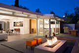 Klopf Architecture, Arterra Landscape Architects, and Flegels Construction joined forces to refurbish this Palo Alto Eichler. Standout features include a fully opening glass wall, an outdoor living area with a kitchen and fire pit, and furniture by Kayu and Primary Pouf. 