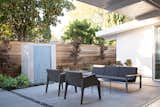 Outside, a contemplative sitting area centers on a fountain clad in tiles by Heath Ceramics. A Case Study Stainless couch by Modernica and Magic Hole armchairs by Kartell are positioned around Jolly side tables by Kartell.