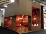 Michael Anastassiades booth in Euroluce. Sadly none of our photos do the wooden jewel box justice, but believe when we say the brass fixtures set off by the warm wood cladding was a joy to see.