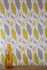 Mustard & Grey Trumpet Leaves from Kiran Ravilious—Each design is hand carved and hand printed on fabric, then photographed and repeated for the wallpaper pattern. $100 a roll.