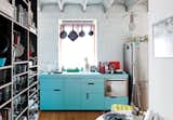 The centerpiece of this new kitchen in Bratislava is the cabinetry, which is an off-the-rack Ikea system resident Lukáš Kordík redid in striking blue. Kordík forwent door handles in favor of cutouts. “I wanted the kitchen to be one simple block of color without any additional design,” he says.  Photo 1 of 7 in Bold Kitchens by Luke Hopping