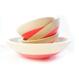 Designer Araya Jensen hand-dips each hand-carved wooden bowl in neon synthetic rubber, so no two bowls are exactly alike. The cheerful result is a tactile, unique piece. We recommend collecting various sizes and displaying them stacked together as shown or as fruit bowls.