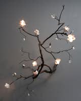 Wiseman employs a myriad of secret engineering devices when creating his chandeliers. The branches are cast hollow to hide wiring. Unique large wall mounted branch illuminated sculpture in bronze with white porcelain blossoms. Designed and made by David Wiseman, USA, 2012. 60" L x 72" W x 60" H. Photo by: Sherry Griffin/R 20th Century.  Photo 5 of 8 in Practice of Patronage