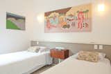 The modern cement interior, with its sophisticated white and slate color scheme, makes a fitting backdrop for an impressive contemporary art collection featuring works by Brazilian artists like Paulo Whitaker, Bruno 9Li, Sesper, and Talita Hoffman. An added bonus: the apartment, located just a block from the beach in happening Leblon, is smartly soundproofed.