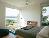 In the master bedroom, a custom ash frame takes advantage of the expansive view.