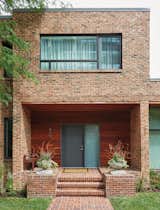 Exterior, Brick Siding Material, and Flat RoofLine Because the house is located in a historic area, the exterior updates were limited to new windows and ipe cladding around the front door.  Search “brick” from An Impressive 20-Foot Skylight Transforms a Jumbled Chicago Home