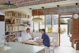 In the eat-in portion of the kitchen, a George Nelson Bubble Lamp hangs above an Artek table and chairs by Alvar Aalto.