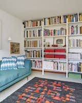 Living Room, Sofa, and Bookcase A pressed-steel Parallel shelving system by Terence Woodgate holds books and mementos.  Search “replenish reusable bottle system” from Quirky 1970s House in the English Countryside Showcases an Amazing Modern Furniture Collection