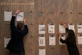 Visitors accept the invitation to design a typeface with pencil and paper, and to vote for their favorite chair via a democratic Tiddlywinks system. Photo by: Max Colson