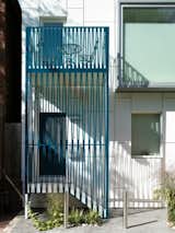 To fulfill the owner's request for a sunny spot to sit outside, Reigo & Bauer created a new balcony and entry porch. With few connections to the building it has the appearance of a free-standing structure, keeping it visually light and airy. The playful zig-zag pattern of the panels give the homeowners some shade and privacy, and a deep turquoise powder coating adds some color to Virtue Street in the winter.