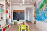 The kids' playroom features built-in storage and a Fly pendant from Design Within Reach. Reddy purchased the mural from World Maps Online and the small table and chairs from Igloo Play.