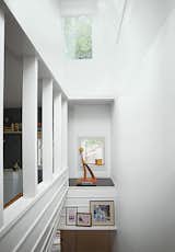 An alcove in the stairwell displays a white ash sculpture by Bradley.