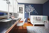 Kids Room, Bedroom Room Type, Bed, and Desk The office, which is also Lily’s room, features a Babyletto crib and a Smileywalls wall decal applied atop Normandy paint from Benjamin Moore.  Photo 4 of 10 in Run-Down Row House in Boston Becomes a Quiet Urban Escape with Two Green Roofs