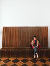 Here, Smith sits on a vintage rosewood bench designed by the Swiss-born British architect Richard Seifert.