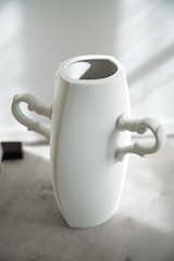The ceramic vase with curvaceous handles was created by Estudio Manus. "We aim to show people that you can live with precious, unique, delicate objects in a very normal and robust way." —Ike Udechuku
