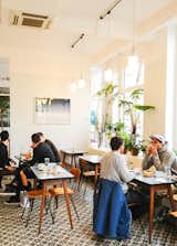 Just a step or two away from the shop is the small café. Open from breakfast until late afternoon, the café offers everything from coffee, tartines, charcuteries, risotto, and flaky brioches to a fine selection of cheeses, wine, and sausages. Photo via Hip Paris.